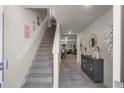 Bright and airy entryway with staircase and storage at 325 Pelham Park Dr, Deland, FL 32720