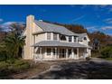 Two-story house with a wrap-around porch and large windows at 3818 Kinsley Place, Winter Park, FL 32792