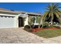 Single story home with a white pergola and landscaped yard at 5114 Jareds Landing Way, Oxford, FL 34484