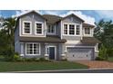 Two-story house with gray siding, brown trim, and a two-car garage at 5232 Prairie Preserve Run, St Cloud, FL 34772