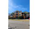 Three-story apartment building with yellow walls and palm trees at 6240 Contessa Dr # 101, Orlando, FL 32829