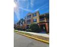 Three-story apartment building with yellow walls and palm trees at 6240 Contessa Dr # 101, Orlando, FL 32829