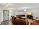 Relaxing living room with hardwood floors and brown couches at 6616 Nw 60Th St, Ocala, FL 34482