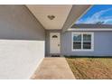 Front entrance with a white door and walkway, showing a modern design at 7080 Hemlock Crse, Ocala, FL 34472