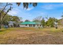 Spacious backyard offering a tranquil setting with mature trees at 750 S Dudley Ave, Bartow, FL 33830