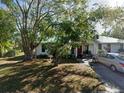 Front yard view of a white single story home with red door at 750 S Dudley Ave, Bartow, FL 33830