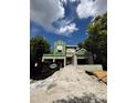 New construction exterior featuring modern design and landscaping, set against a partly cloudy sky at 785 N Phelps Ave, Winter Park, FL 32789