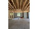 Spacious garage under construction features block walls, wooden ceiling joists, and window openings offering natural light at 785 N Phelps Ave, Winter Park, FL 32789