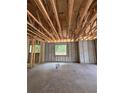 Unfinished interior showcasing concrete flooring, block walls, and exposed wood beams, full of potential at 785 N Phelps Ave, Winter Park, FL 32789