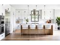Modern kitchen features white cabinets, stainless steel appliances, a large island, and bar stool seating at 785 N Phelps Ave, Winter Park, FL 32789