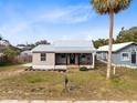 Newly renovated home with gray siding, metal roof and a large yard at 1114 Wyoming Ave, St Cloud, FL 34769