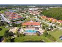 Community pool and clubhouse with surrounding landscape at 1230 Las Fuentes Dr, Kissimmee, FL 34746