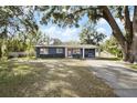 Ranch-style home with red door and carport at 128 Tildenville School Rd, Winter Garden, FL 34787