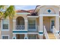 Condo building exterior, featuring arched entryways and balconies at 13917 Timberland Dr # 201, Orlando, FL 32824