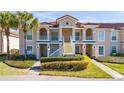 Two-story condo building with a tiled roof and lush landscaping at 13917 Timberland Dr # 201, Orlando, FL 32824