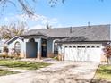 House exterior featuring a light blue facade and a spacious driveway at 16143 Palmetto Hill St, Clermont, FL 34714