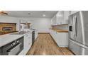 Modern kitchen with white cabinets and butcher block countertops at 1719 Finley Ave, Apopka, FL 32703