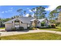 Brick house with gray roof, yellow door, and landscaped yard at 217 Pleasant Valley Dr, Daytona Beach, FL 32114