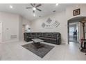 Spacious living room featuring a sectional sofa and ceiling fan at 220 Foxtail Loop, Davenport, FL 33837