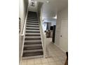 Staircase with wood-look risers and carpet at 2407 Silver Palm Dr, Kissimmee, FL 34747