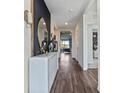 Bright and spacious entryway with dark accent wall and modern console table at 2924 Moulin Rd, Davenport, FL 33837