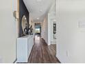 Bright entryway with white console table and dark accent wall at 2928 Moulin Rd, Davenport, FL 33837