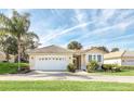 Well-maintained single-story house featuring a two-car garage at 303 Foxhill Ct, Debary, FL 32713