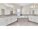 Elegant bathroom featuring a corner soaking tub and double vanities at 3138 Dark Sky Dr, Harmony, FL 34773