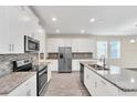 Spacious kitchen with granite countertops and stainless steel appliances at 3138 Dark Sky Dr, Harmony, FL 34773