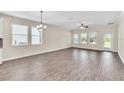 Bright and airy living room with wood-look flooring at 3138 Dark Sky Dr, Harmony, FL 34773