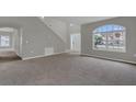 Spacious living room features a large arch window, neutral paint, and plush carpeting at 370 Aldershot Ct, Kissimmee, FL 34758