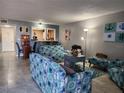 Living room with nautical themed decor, including couches, chairs, and tile floors at 400 Auburn Dr # 3, Daytona Beach, FL 32118