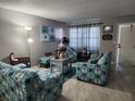 Living room with nautical themed couches, chairs, a table and tile floors at 400 Auburn Dr # 3, Daytona Beach, FL 32118