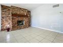 Living room with brick fireplace and tiled floor at 4400 Southmore Dr, Orlando, FL 32812