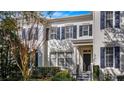 Front view of a charming townhome with dark shutters and landscaping at 5419 Baldwin Park St, Orlando, FL 32814