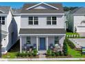 Two-story house with gray siding, a front porch, and landscaping at 5586 Stockade Blvd, St Cloud, FL 34771