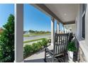 Relaxing front porch with rocking chairs and view of a pond at 5586 Stockade Blvd, St Cloud, FL 34771