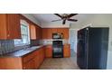 Bright kitchen with wood cabinets, granite countertops, and modern appliances at 610 Thomas Ave, Winter Haven, FL 33880