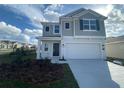 Charming two-story home featuring a two-car garage, well-manicured lawn and pleasant curb appeal at 768 Staffora St, Haines City, FL 33844