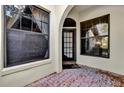Exterior entryway with brick flooring, arched entryway, and windows at 140 Stratford Ct, Haines City, FL 33844