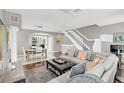 Spacious living room with hardwood floors, sectional sofa, and dining area at 1407 Chatfield Pl, Orlando, FL 32814