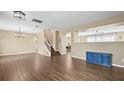 Spacious dining room with wood-look floors and a view into the kitchen at 14236 Golden Rain Tree Blvd, Orlando, FL 32828