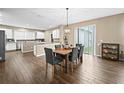 Kitchen with island, stainless steel appliances, and eat-in dining area at 14236 Golden Rain Tree Blvd, Orlando, FL 32828