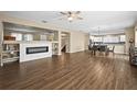 Open living and dining area with hardwood floors and a modern fireplace at 14236 Golden Rain Tree Blvd, Orlando, FL 32828