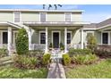 Front view of a two-story house with a porch and well-manicured landscaping at 14531 Clarkson Dr, Orlando, FL 32828