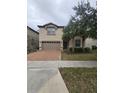 Two-story house with a brown brick driveway and palm trees at 1662 Lima Ave, Kissimmee, FL 34747