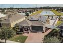 Aerial view of a house with solar panels and a landscaped backyard at 1809 Hawksbill Ln, St Cloud, FL 34771