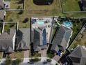 An aerial view showcasing a neighborhood with multiple homes and pools at 1809 Hawksbill Ln, St Cloud, FL 34771