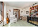 Cozy living room with comfortable seating, bright light, and a large bookshelf at 2351 Mandarin Rd, Deland, FL 32720
