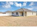Home's backyard with covered patio and grassy area at 2860 Ne 42Nd Rd, Ocala, FL 34470